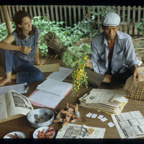 Joyce and Li discussing plants in Ban Chiang village, 1979-1981